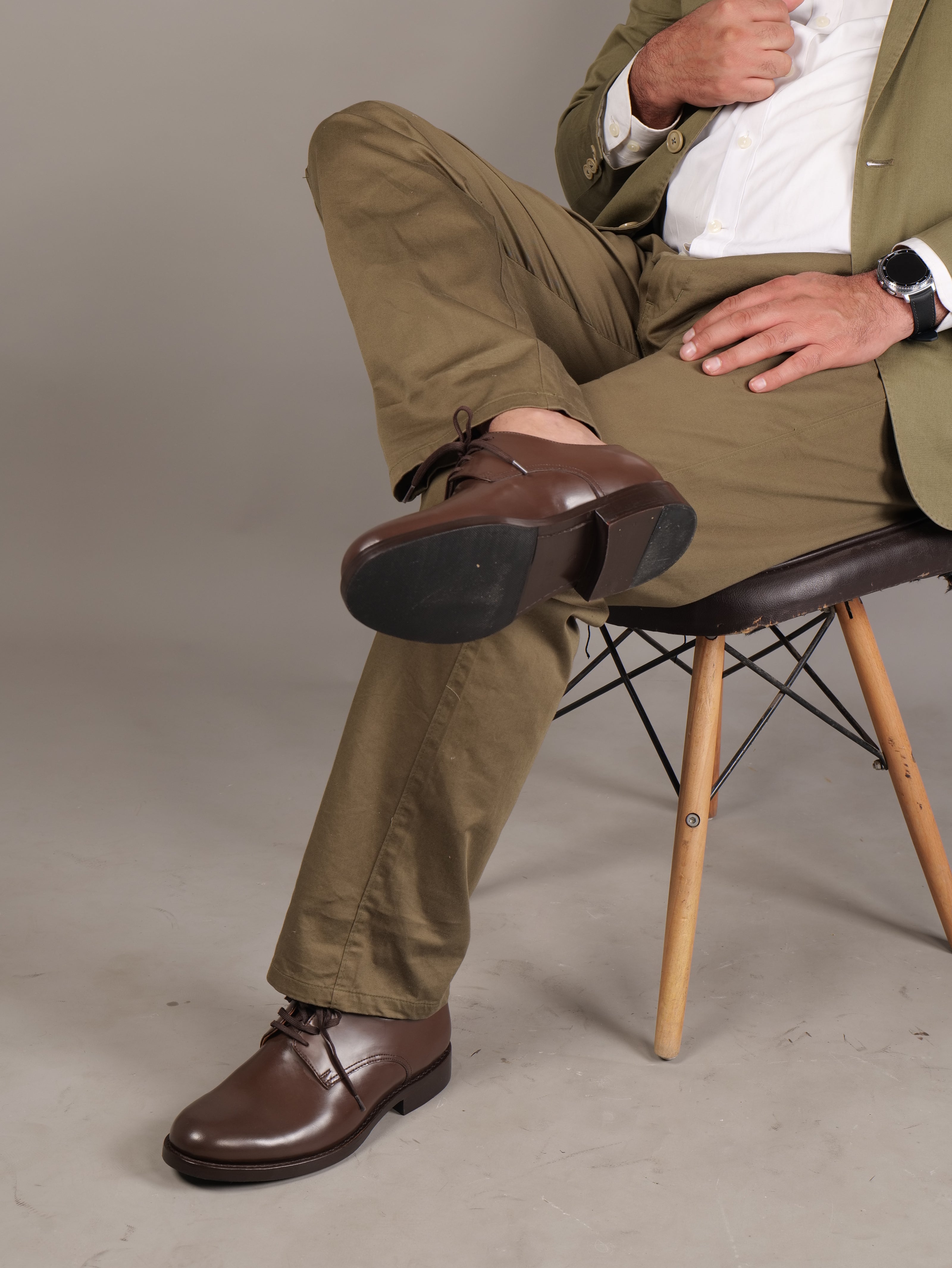 Handmade men’s brown leather shoes by Blucher, luxury footwear for professionals, seated view