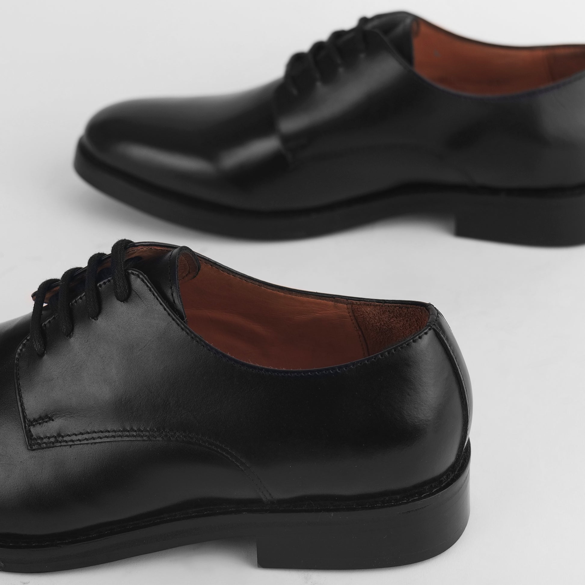 Back view of black leather Blucher Stud Series shoes showing heel and rear design