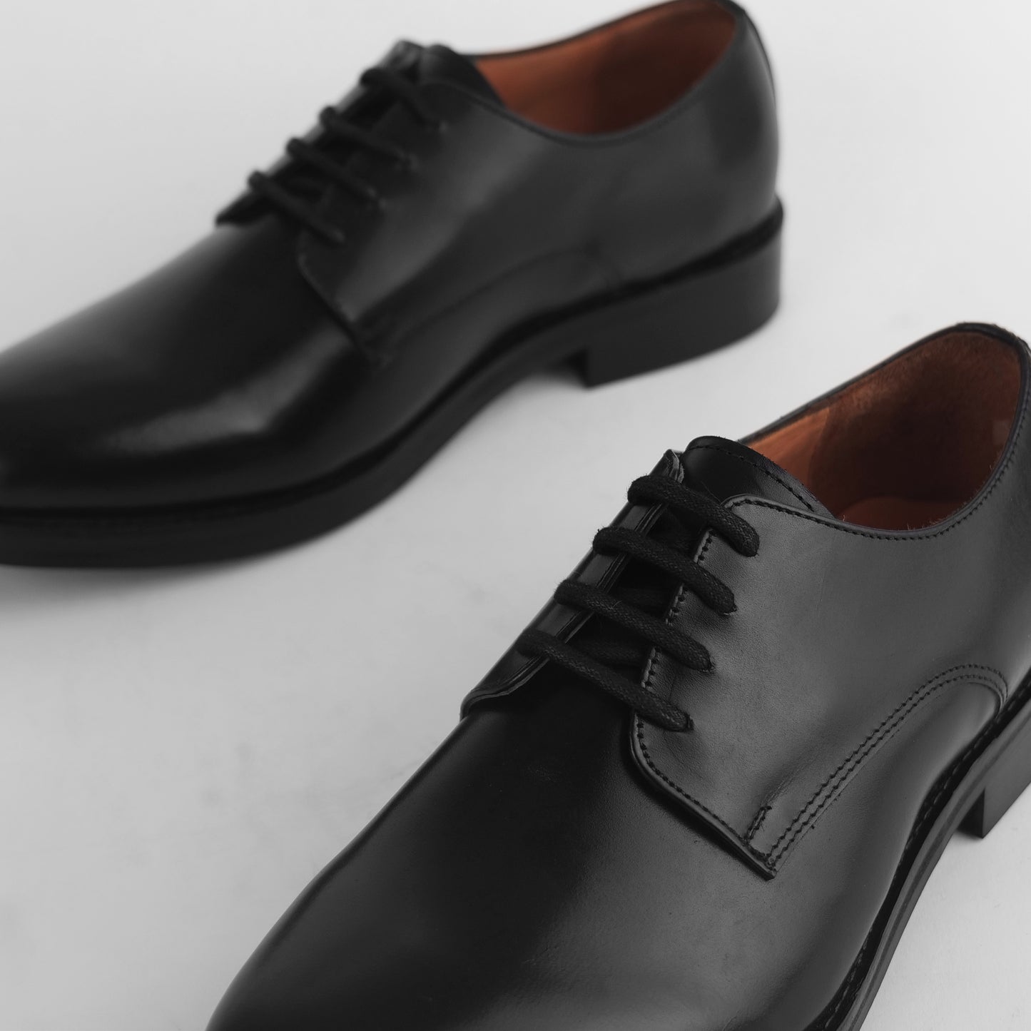 Close-up of black leather Blucher Stud Series shoe highlighting lace detail