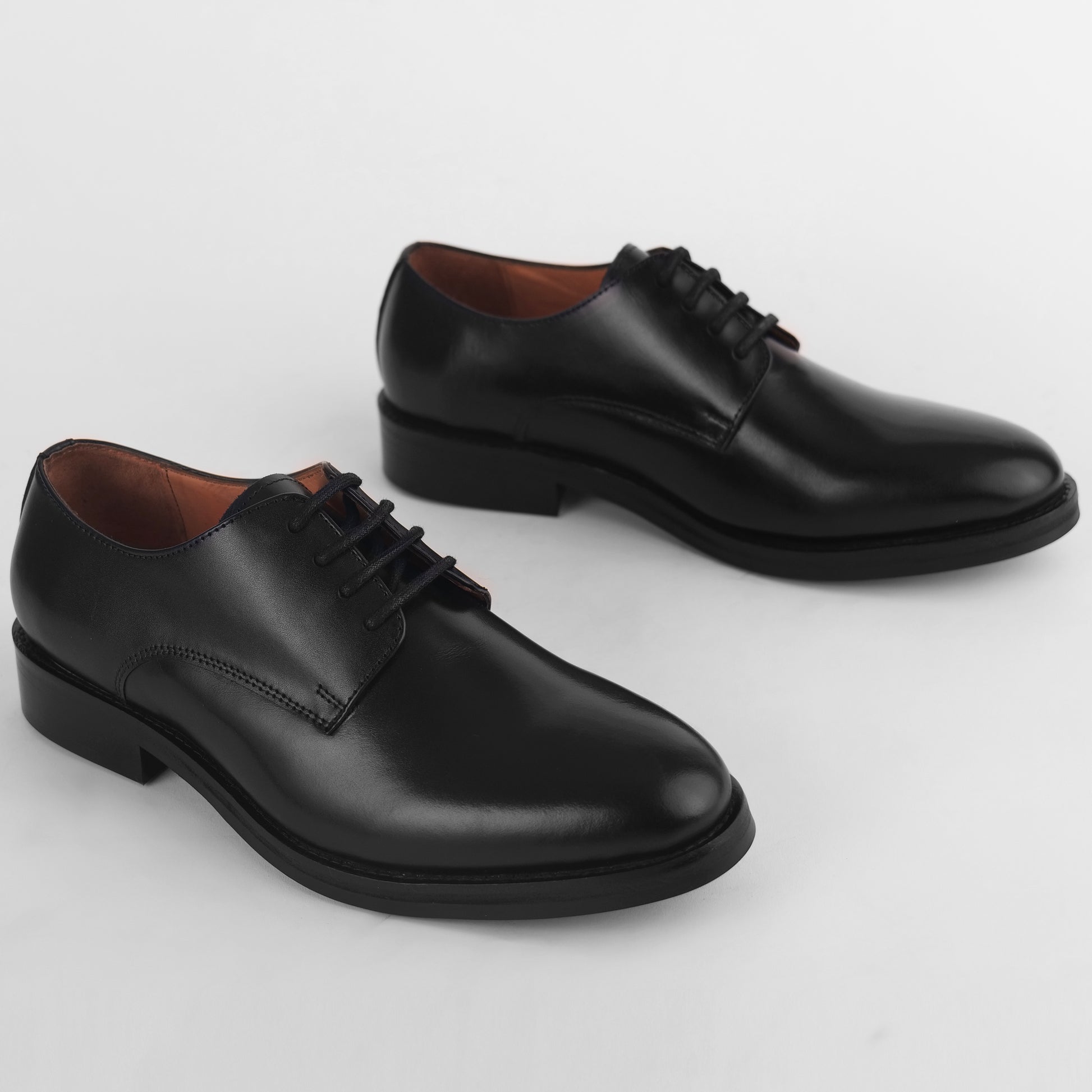 Top view of black leather Blucher Stud Series shoes showing overall pair design