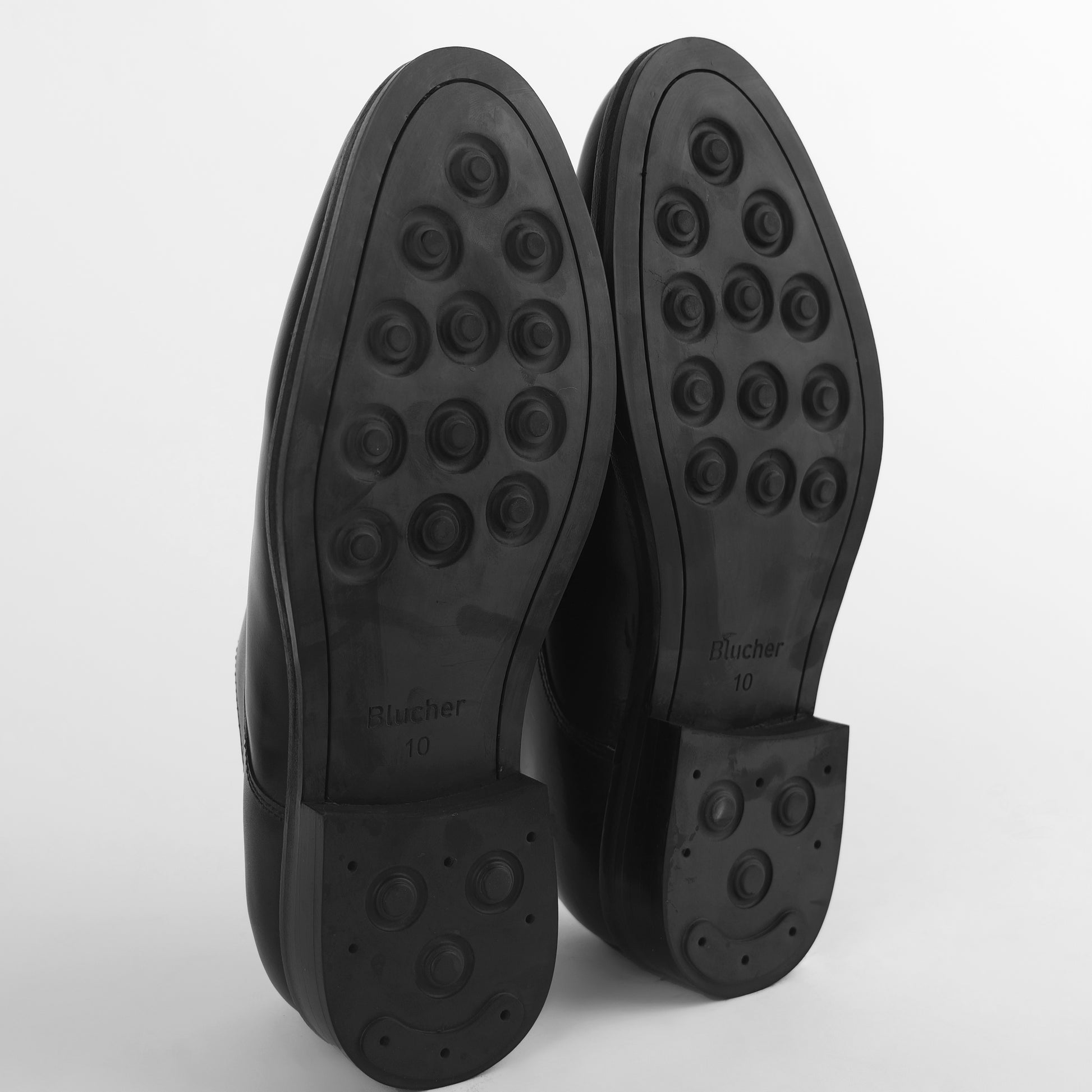 Bottom view of black leather Blucher Stud Series shoes showing studded rubber sole