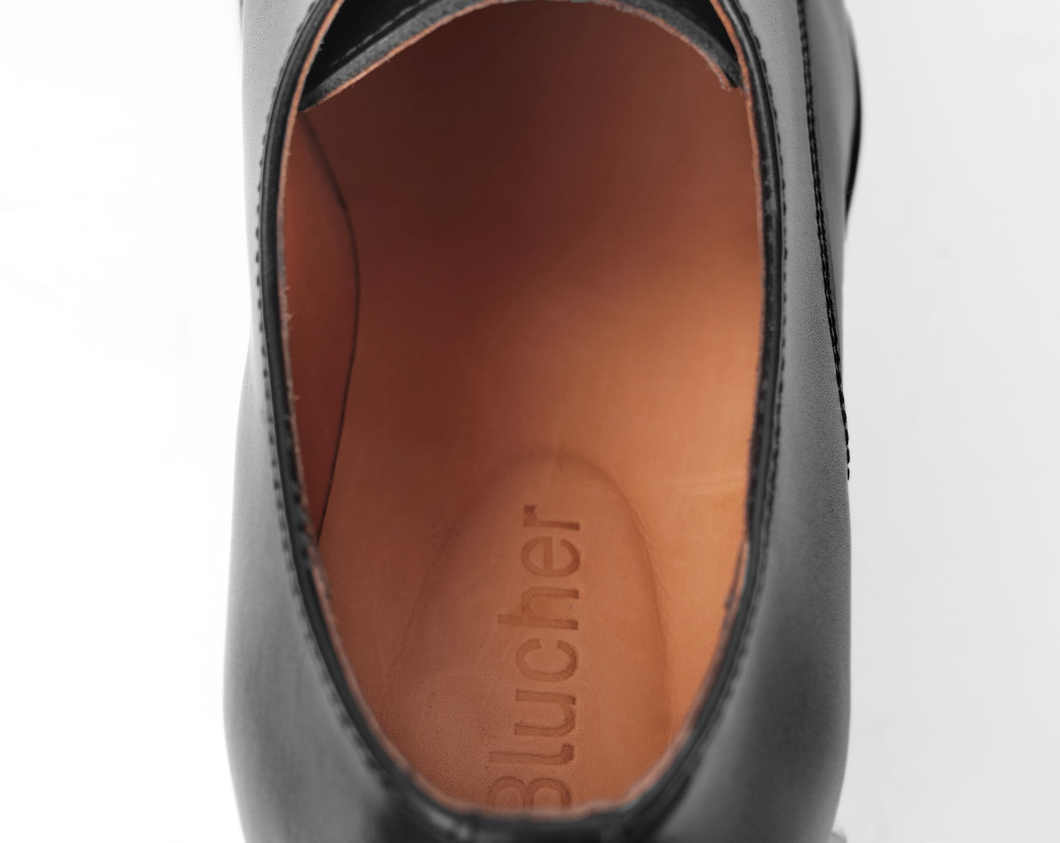 Interior view of black leather Blucher stud sole shoe showing cowhide leather lining