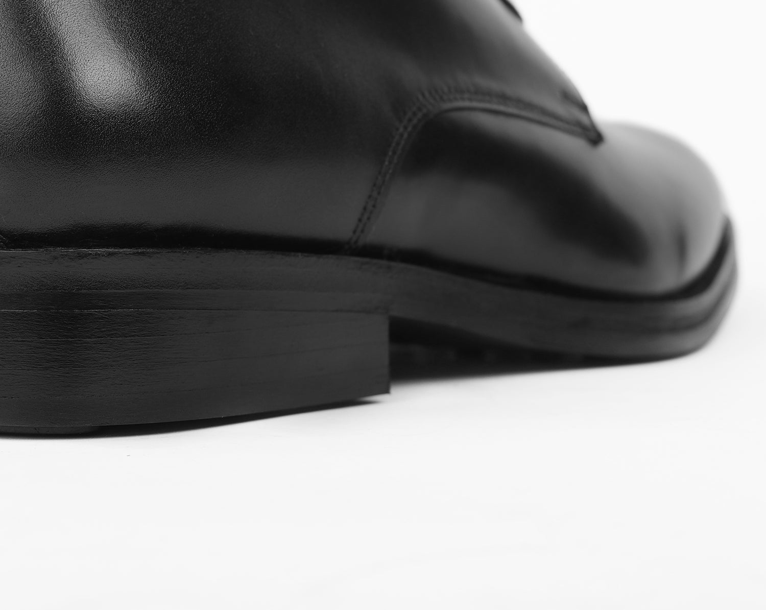 Footbed of black leather Blucher stud sole shoe showing strong layered heel construction