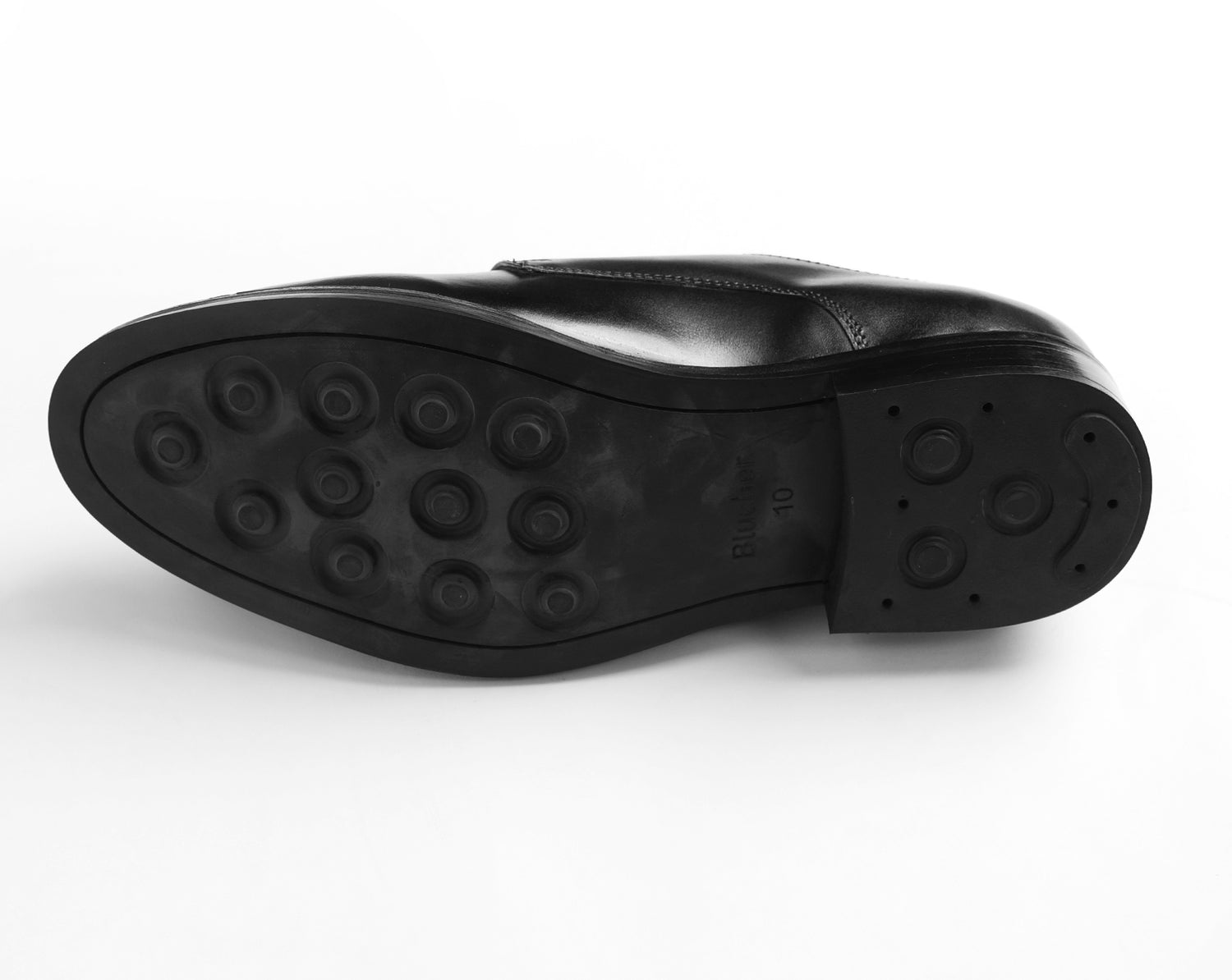 Studded sole of black leather Blucher shoe highlighting strong grip and traction