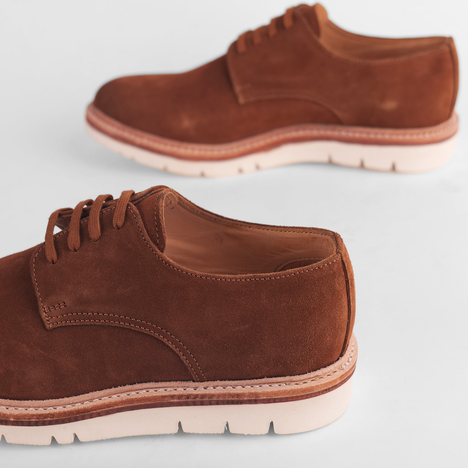 Side view of a pair of brown Blucher Suede shoes
